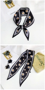 Detail of floral skinny scarf with white daisies and stripe edges for summer styling