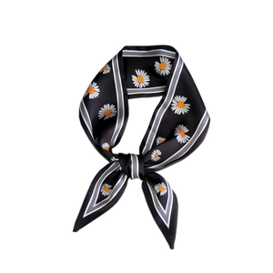 Elegant black silk scarf featuring white daisy prints and striped borders for versatile styling