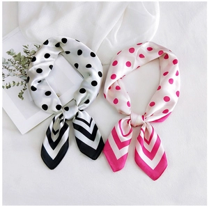 Detailed view of silk-feel square scarves with elegant polka dots and striped patterns