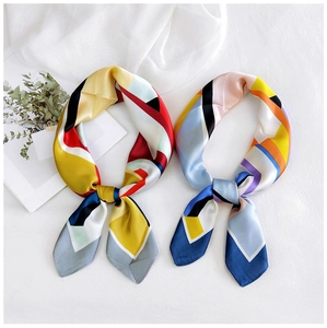Macro detail of geometric pattern silk scarves tied as elegant neckerchief accessories
