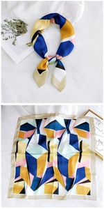 Close-up of geometric pattern satin square scarf with modern blue and yellow block design