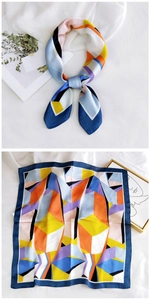 Detail of artistic geometric patterned silk scarf with vibrant colors and smooth texture