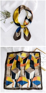 Detail of satin square scarf with colorful geometric blocks and artistic textures