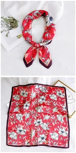 Detail showing red floral silk scarf with large white petals and purple hem detail
