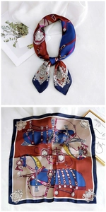 Detail of square silk scarf with vintage equestrian emblems and horse crest patterns