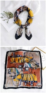 Detailed equestrian print silk scarf showing vintage horse bit and strap patterns