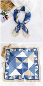 Macro detail of 70cm square silk scarf featuring blue geometric triangle patterns