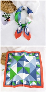 Detail showing colorful geometric square silk scarf with green and blue patterns