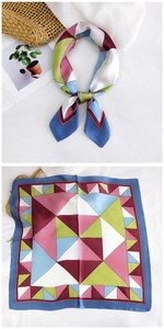Detail of colorful geometric silk scarf showing folded knot and flat triangular pattern