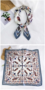 Detail view showing bohemian feather pattern and smooth texture of the 70cm silk scarf