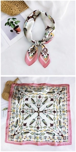 Detail of bohemian silk scarf featuring pink feather patterns and geometric ethnic prints