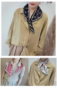 Detail of silk-like neck scarves with geometric triangles and elegant clasp style