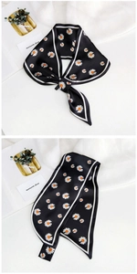 Detail of black silk scarf with daisy prints and elegant white borders for decoration