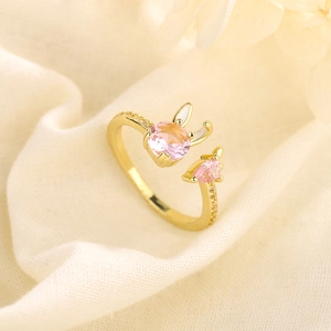 Adjustable rabbit and carrot ring featuring pink zircons and gold plated metal