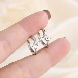 Elegant s925 silver star hoop earrings with zircon pavé held for scale