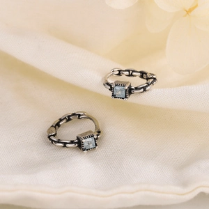 S925 vintage silver sugar cube earrings with blue crystal on beige fabric background