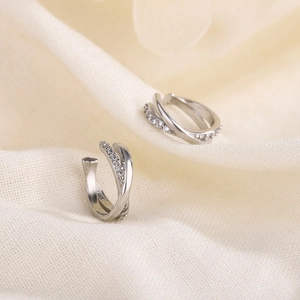 Silver crisscross zircon ear cuff with sparkling stones and polished minimalist lines