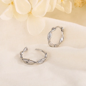 Minimalist S925 silver twisted hoop earrings with micro-set zircon on white linen cloth