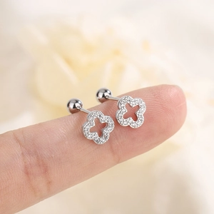 Gros plan sur boucles d'oreilles trèfle évidé en argent avec zircons et fermoir à vis