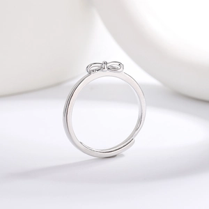 Polished silver bow ring with adjustable open band design on a clean white background