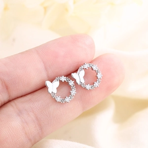 Exquisite S925 silver butterfly hoop earrings with pavé crystals held in hand