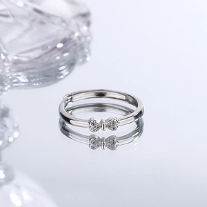 S925 sterling silver bow ring with zircon stones on white reflective background