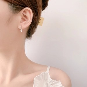 Elegant s925 silver star and moon drop earrings worn by a model in a close-up shot