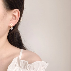 French style gold geometric square stud earrings with elegant white round pearls on model
