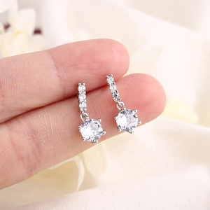 Elegant silver drop earrings with sparkling cubic zirconia stones shown on hand