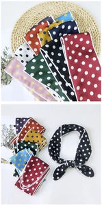 Close-up of assorted polka dot satin scarves showing various colors and silk texture
