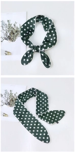 Detail of dark green silk-like scarf with white polka dots and delicate white edge trim