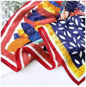 Detail of silk square scarf showing colorful abstract prints and premium rolled edges