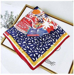 Detail of floral silk square scarf showing intricate pattern and red stitched edges