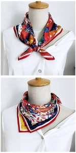 Detail of multi-color floral silk scarf tied on mannequin with a smooth satin finish