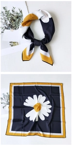 Detail of navy silk square scarf featuring white daisy prints and colorful borders