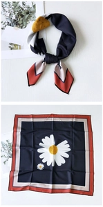 Detail of navy silk square scarf featuring white daisy prints and a tricolor border