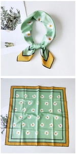 Detail of green square silk scarf with white daisy print and yellow borders shown flat