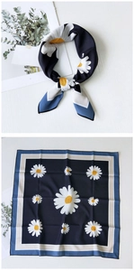 Macro view of navy square silk scarf with daisy pattern and geometric blue borders