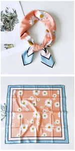 Close-up of silk-feel square scarf with daisy prints and blue contrast borders