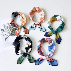 Five assorted floral and geometric silk scarves with daisy patterns for professional styling