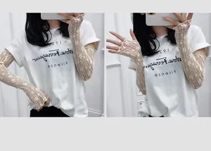 Detail of white lace sun protection sleeves with floral patterns and scalloped edges