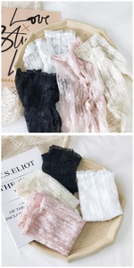 Detailed macro shot of floral lace arm sleeves with ruffled edges in four elegant colors