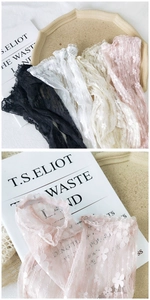 Close-up of floral lace arm sleeves with elegant ruffled edges in multiple colors