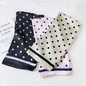 Set of three polka dot silk scarves in black, pink, and beige displayed on a white background