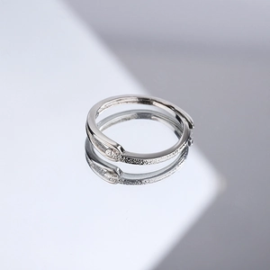 Minimalist adjustable silver ring featuring a frosted matte texture on a reflective surface