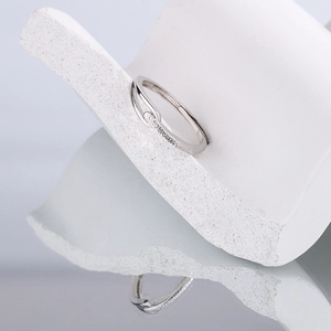 Minimalist 925 silver overlapping ring with matte and polished texture on white stone