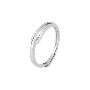 Detail of minimalist silver ring with twisted frosted and polished finish textures