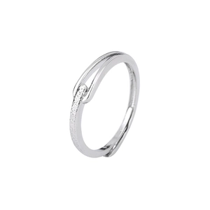 Minimalist silver geometric ring featuring a wrap-around buckle design with textured detail