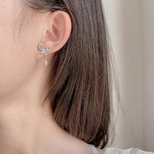 Elegant butterfly stud earrings with colorful zirconia stones worn by a model in silver finish