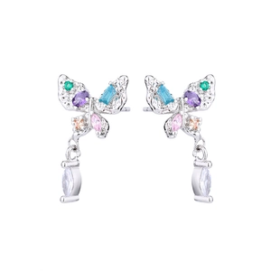 Macro detail of butterfly earrings with colorful zircon stones and silver pendants